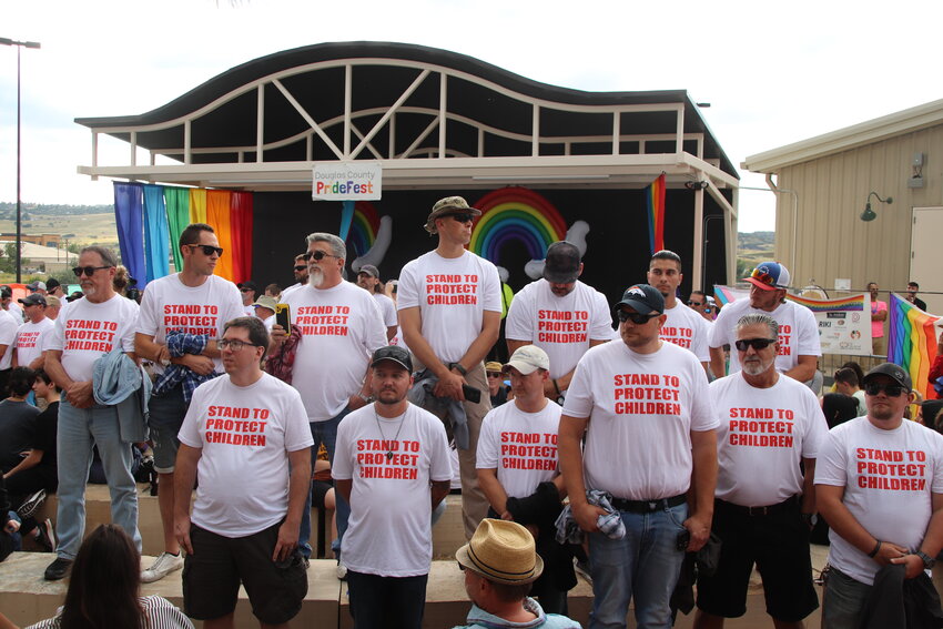 Members of Able Shepherd stand in front of the stage at PrideFest on Aug. 26 to block the family-friendly drag show. Protesters were eventually asked to move so that the stage was visible and the show could continue.
